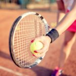 close up portrait of tennis racquet with fitness girl. healthy training for sportswoman details